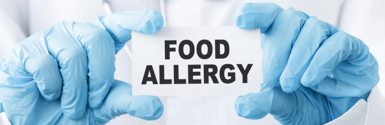 Doctor holding a card with text Food Allergy
