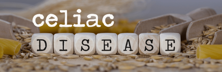 Words CELIAC DISEASE composed of wooden dices. Rye grains in the background.